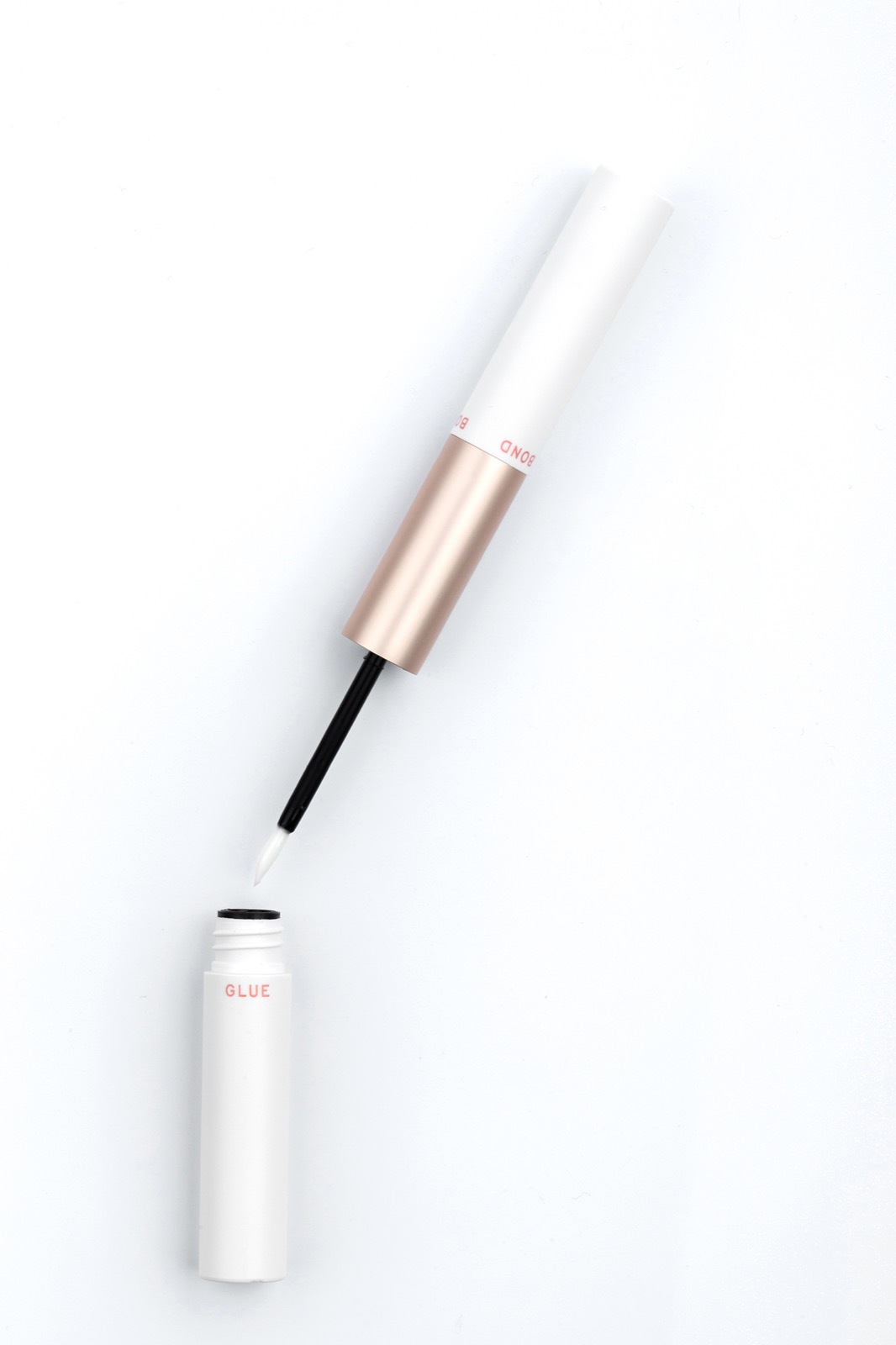 Open physical DIY brush-on container showing the applicator geometry