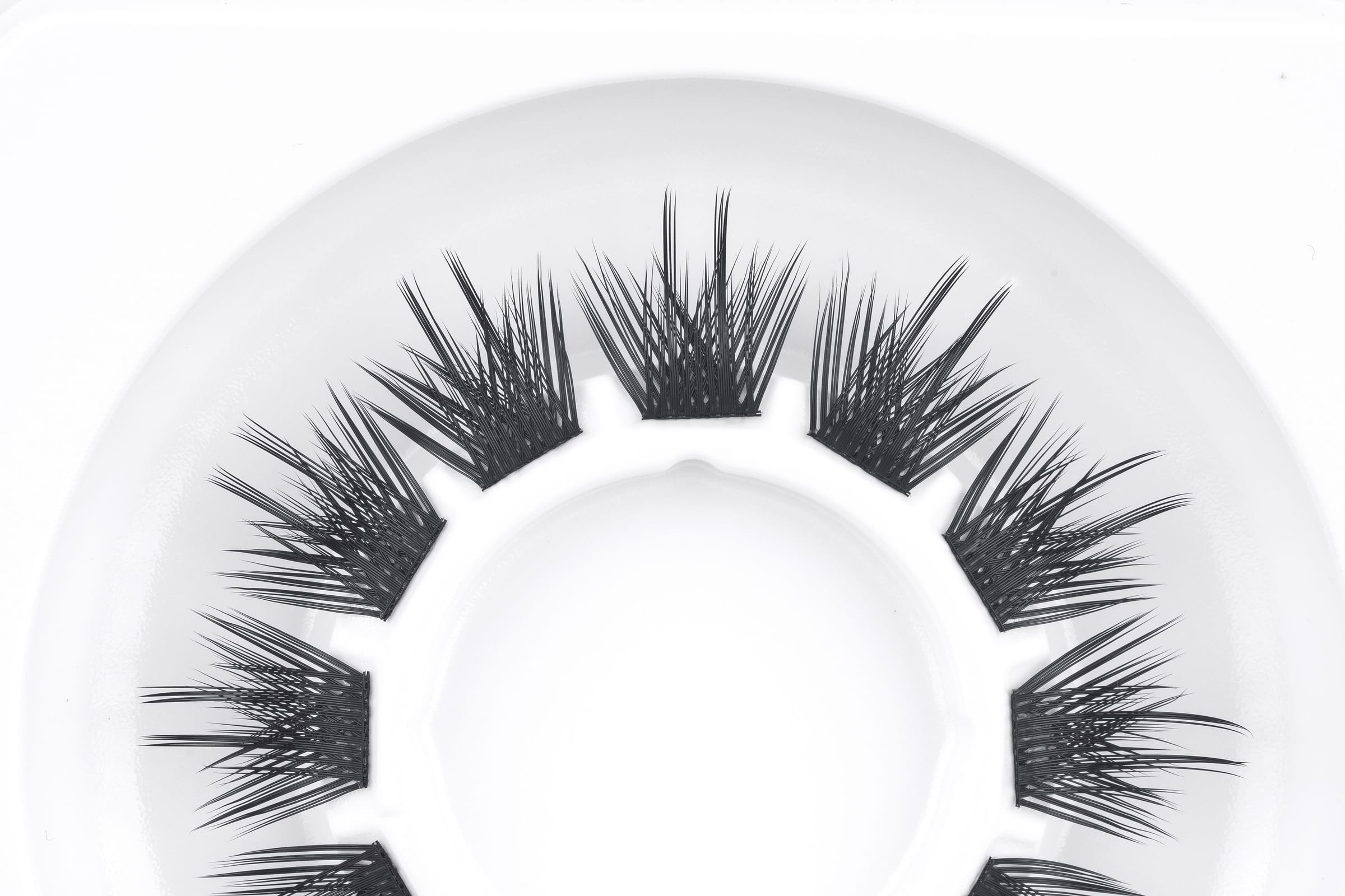 Original photograph of black LSJ linked-band DIY lash segments on a white tray